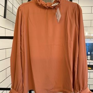 Super cute orange ruffle neck blouse